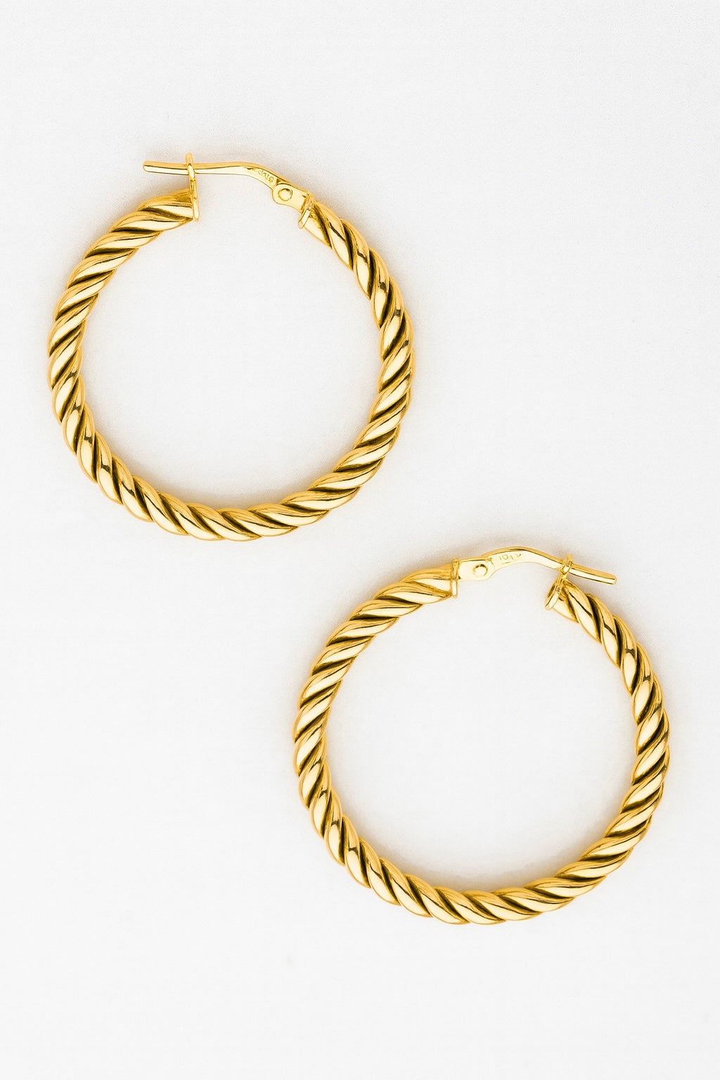 Pair of gold hoop earrings on a white background