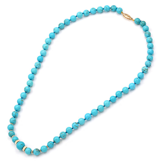 A turquoise beaded necklace with small round blue-green beads and gold-toned spacer accents, displayed on a clean white background.