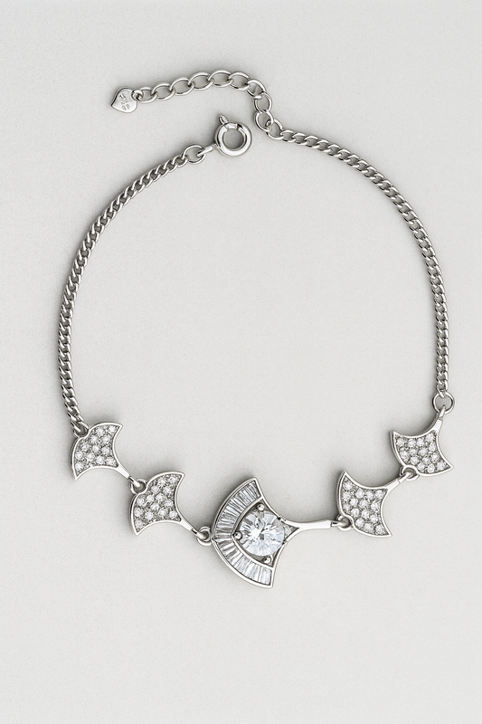 Silver bracelet with decorative elements on a light gray background