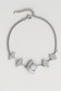 Silver bracelet with decorative elements on a light gray background