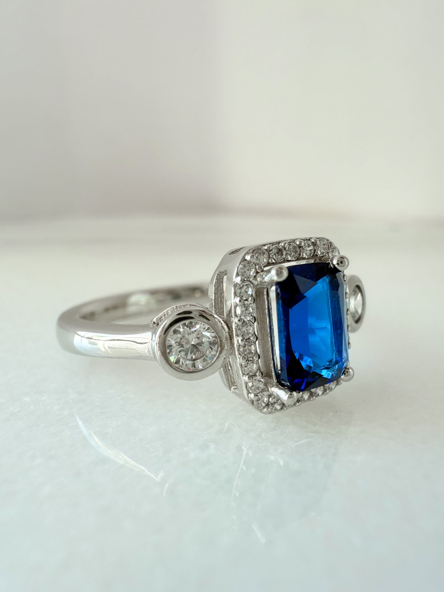 Sterling Silver Sapphire-Blue Rectangle Ring with Zircon Halo & Side Stones