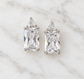 Sterling silver rectangular and triangular cubic zirconia stud earrings on white marble